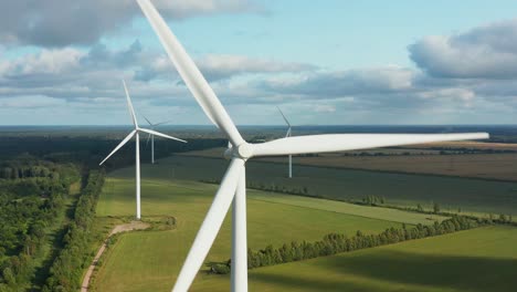 close up of a rotating wind turbine with wind turbine park in the background