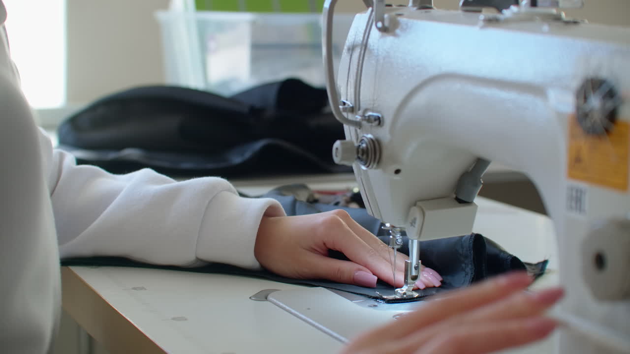 una máquina de coser en movimiento. cortar y coser. fábrica de prendas de vestir. fábrica de textiles. herramientas para coser