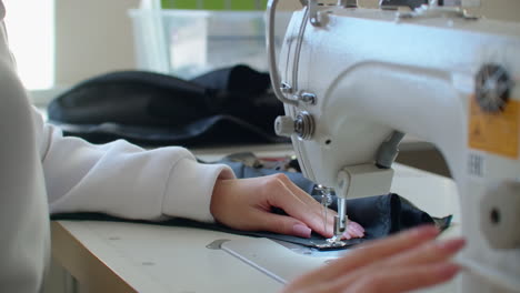 a sewing machine in motion. cutting and sewing. garment factory. textile factory. tools for sewing