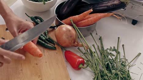 overhead view of cutting out part of a leftover carrot to avoid food wastage, shows a sustainable and zero waste lifestyle