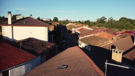 drone forward shot of orange and brown rooftops on a sunny day