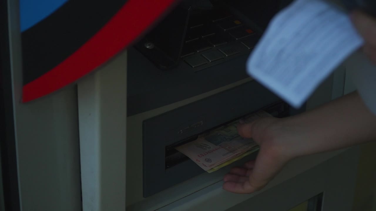 Caucasian person withdrawing cash notes from Romanian bank ATM, close up