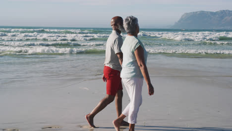 Pareja-Afroamericana-De-Alto-Rango-Caminando-Y-Tomándose-De-La-Mano-En-La-Playa