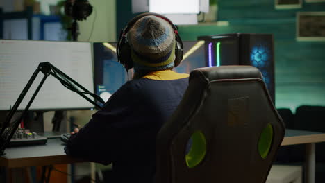 Back-shot-of-pro-gamer-woman-playing-first-person-video-games