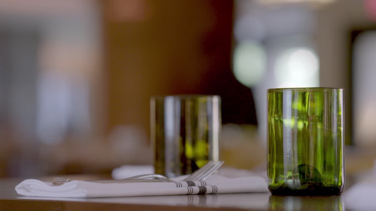a mid shot of a cozy Vermont restaurant interior, featuring a set wooden table with warm lighting and rustic decor in the background.