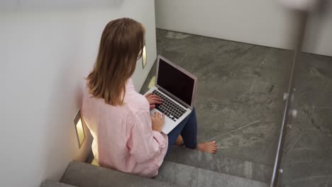 caucasian woman using laptop in hotel