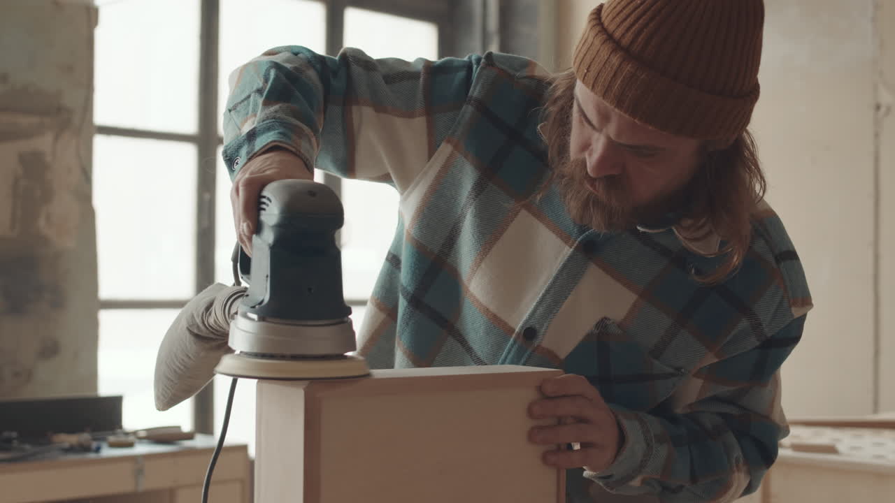 Craftsman Polishing Wooden Box in Workshop