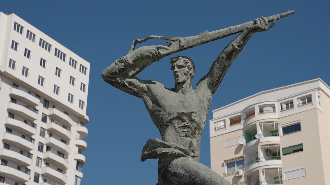 Statue of soldier with rifle in Durres in Albania, handheld shot from below