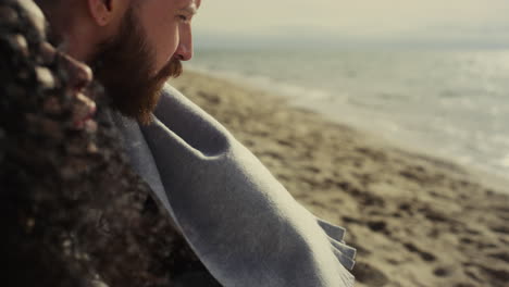 multiethnic couple looking beach. thoughtful people relaxing at sea outdoors.