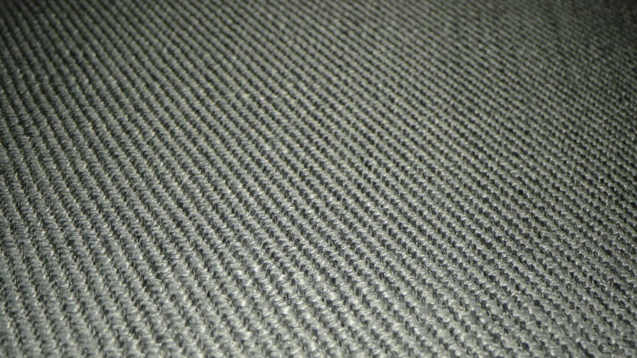 la tela del sofá en la sala de estar con un material hecho a través del tejido - primer plano