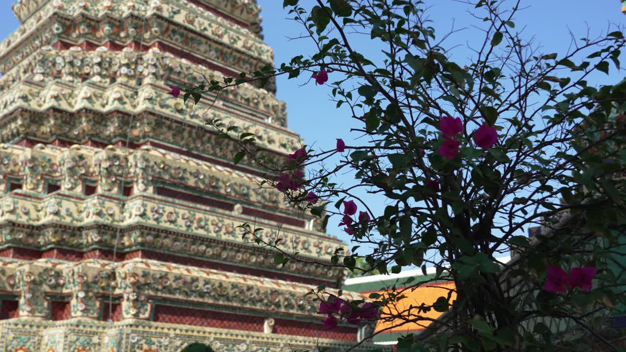 Wat Pho, Bangkok. Majestic exterior architecture featuring colorful mosaic ceramic tile decoration on a towering Thai temple chedi. Ideal for travel, history, and culture