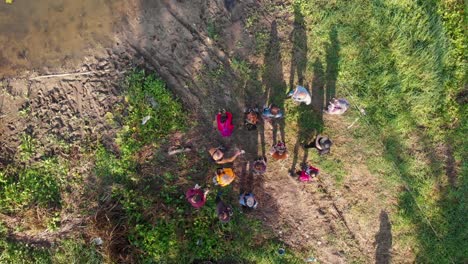 aerial downward drone flight while photographers practice by the river