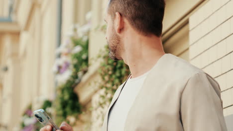 man texting on smartphone in city