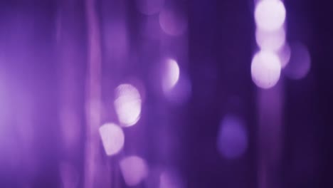 video of flickering white and purple bokeh spots of light with copy space