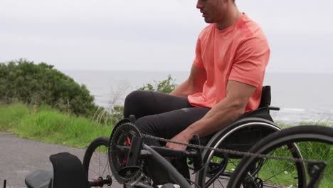 disabled man getting on his wheelchair