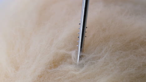 close-up of wool and felting needle