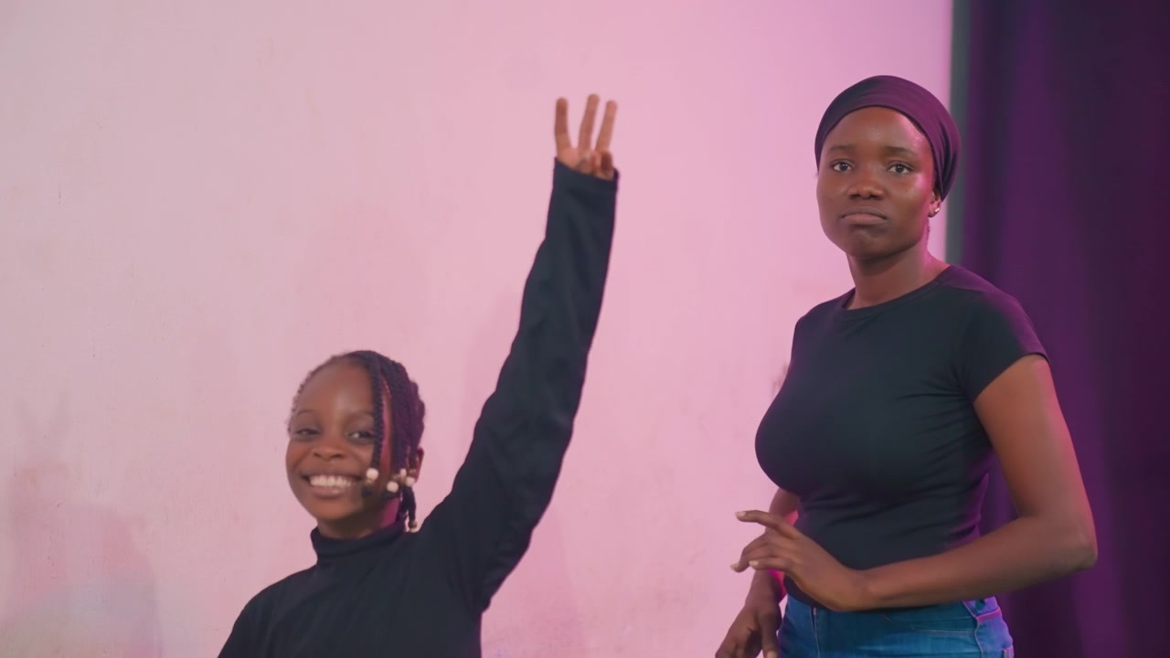 Guiding during rehearsal with pride. Mentoring moment as mother encourages daughter in performance. Supportive mother guiding her daughter through stage rehearsal with pride and encouragement