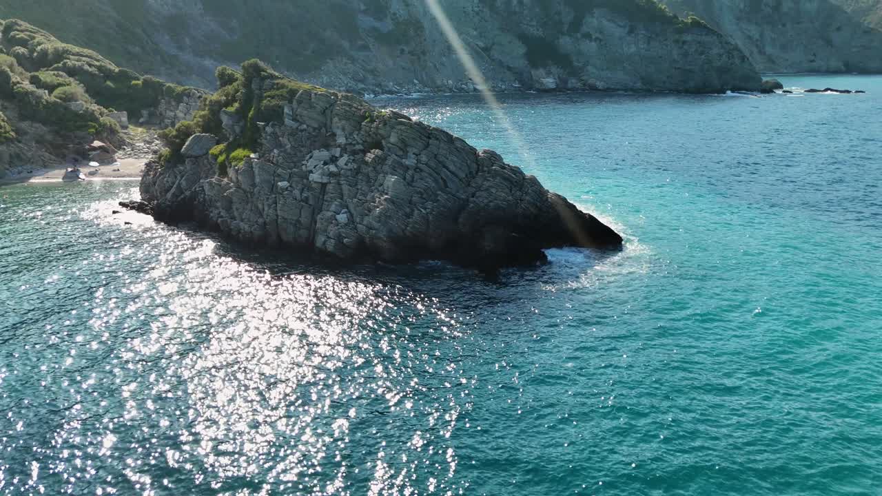 은 파란 물과 절벽을 비추는 빛이 있는 바위가 있는 해안선