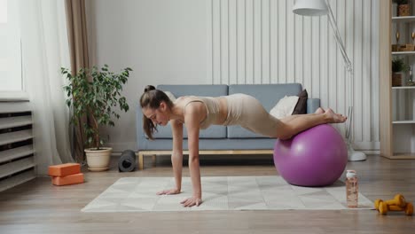 woman exercising with stability ball at home