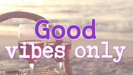 animation of the words good vibes only in purple and white over two glasses of wine at beach by sea