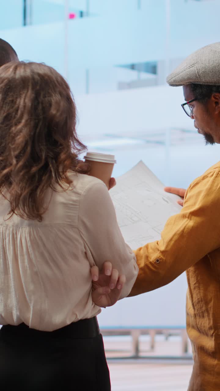 Architetti che discutono piani di costruzione in un ufficio moderno.