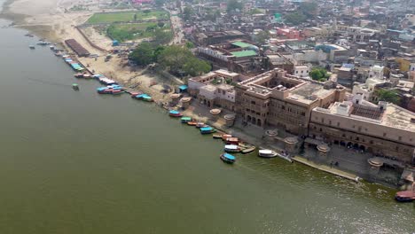 Aerial-fly-by-above-the-river-shoreline-in-the-city-of-Mathura,-India