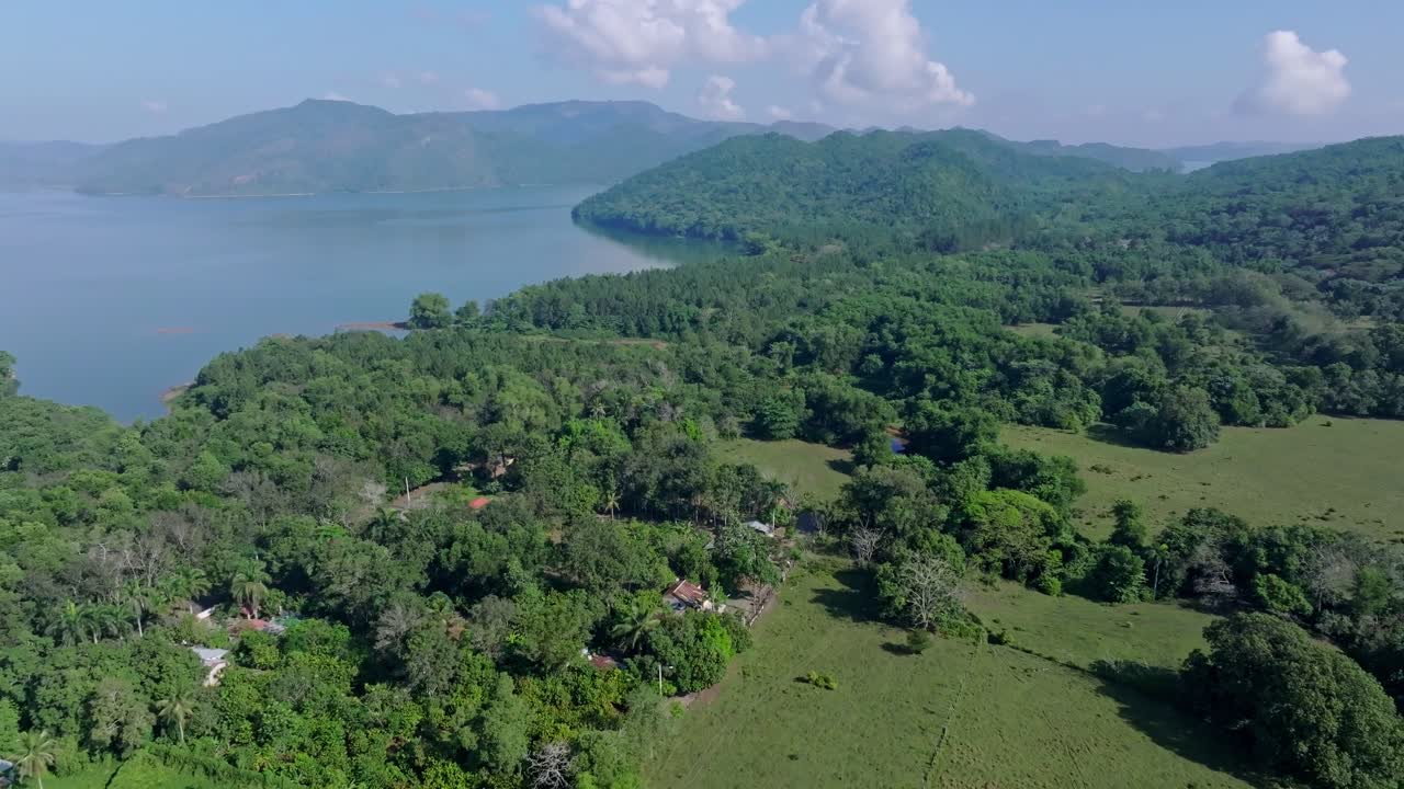 Drone dolly-in over forest and bay in Aniana Vargas National Park, Cotuí, Dominican Republic.