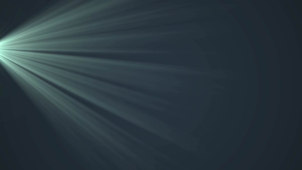 Glowing green rays of light moving against black background