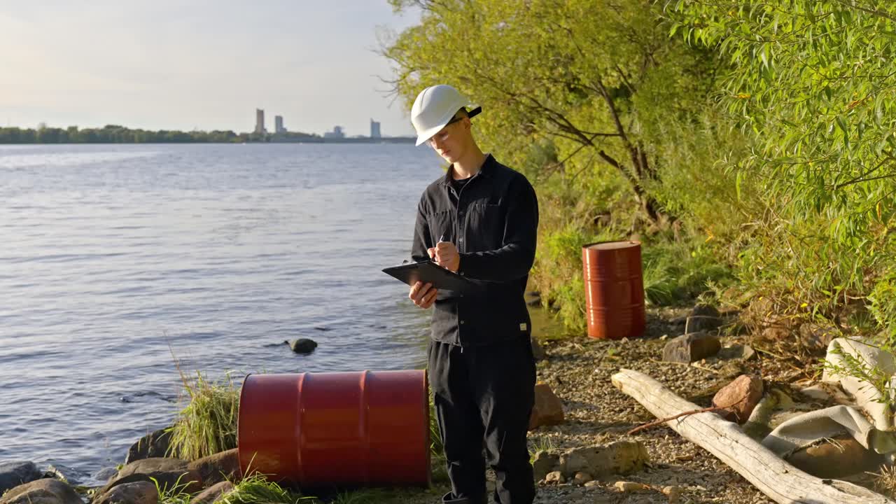Engineer tests water pollution by river under sunny sky for clean future