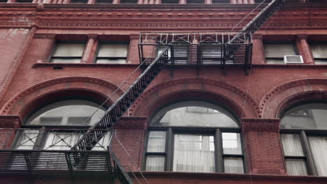 traditional brownstone with fire escape.
low angle pan