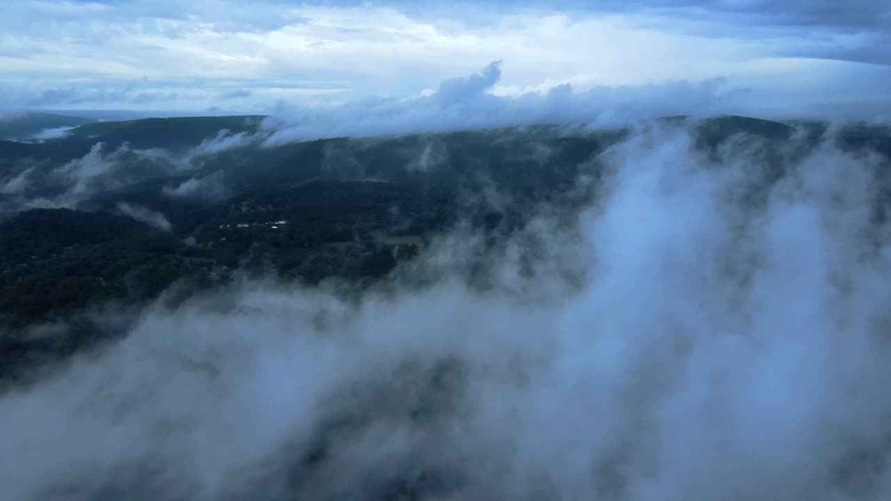 Aerial drone video footage of low clouds over the Appalachian mountains during summer. This is in New York's Hudson Valley on Shawangunk Ridge, which is a sub-range of the Appalachians.
