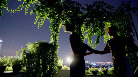 couple dancing on a rooftop at night