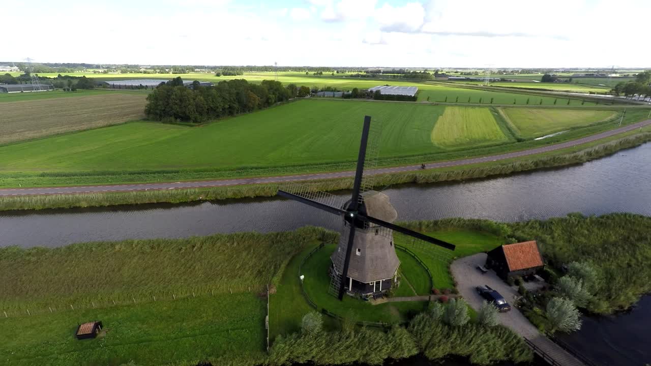 Flying away from windmill on dike