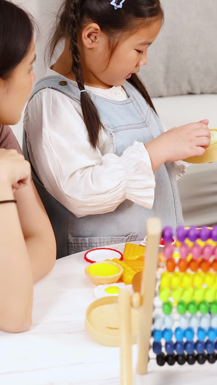 Mother and Daughter Playing with Toy Food