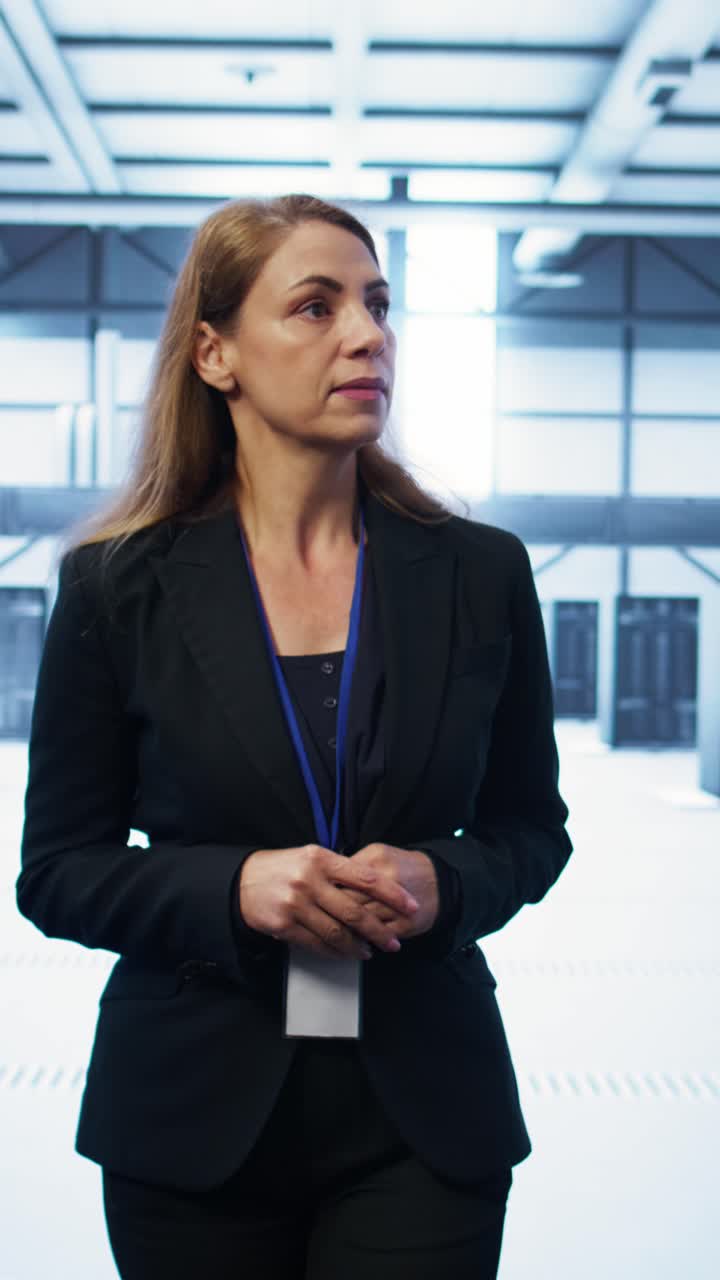 Professional Woman Standing and Observing in a Data Center
