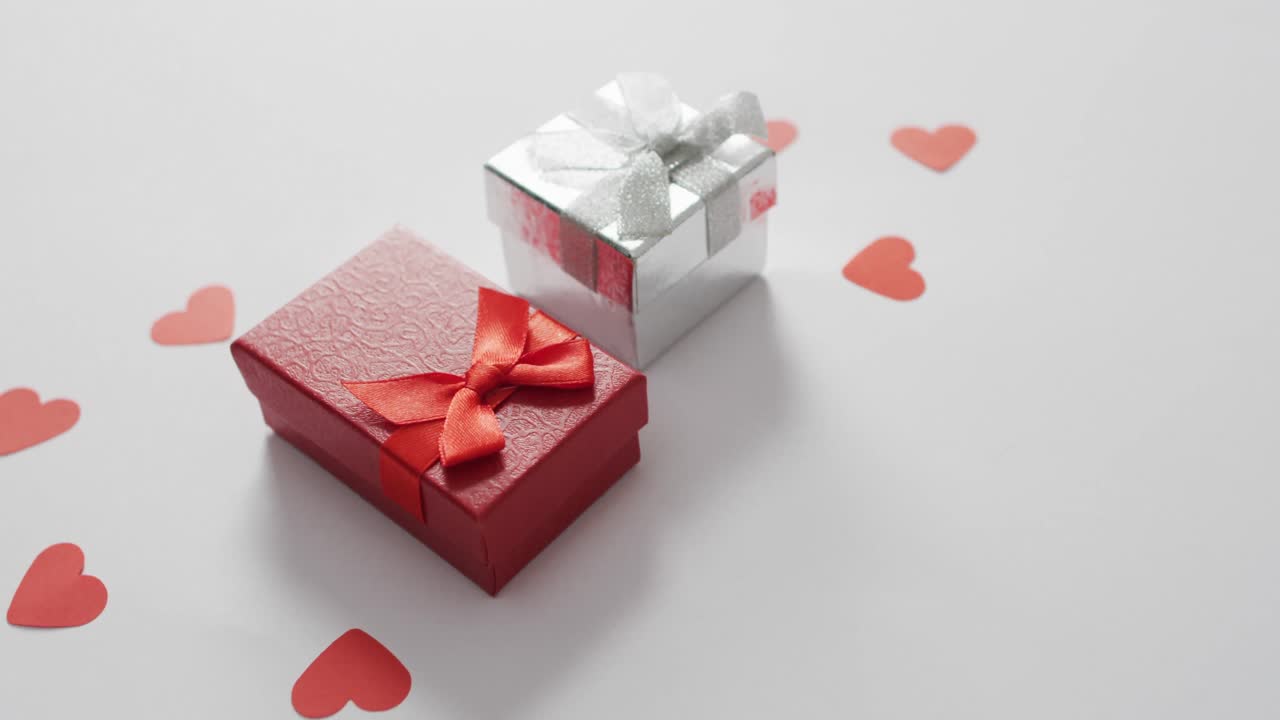 Paper hearts and gifts on pink background at valentine's day