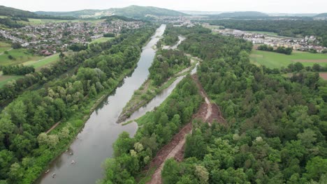 drone shot of a river restoration project in aarau, switzerland. a new river arm is being dug in the forest.