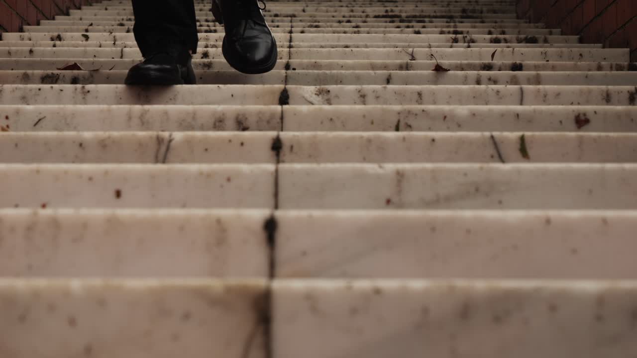 Business man tourist person with umbrella and raincoat on rainy european city street, lights reflecting, walking in Barcelona or Amsterdam during the rain