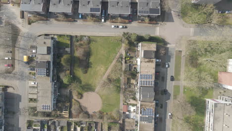 top down aerial of beautiful suburban neighborhood with traffic on the road