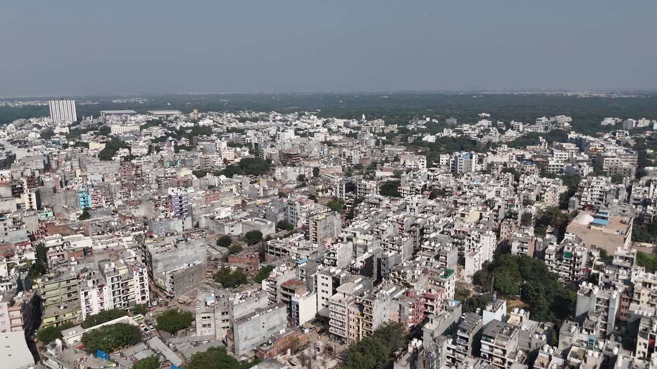 Drone shot highlighting blue-tinted corporate towers in the city’s main tech district