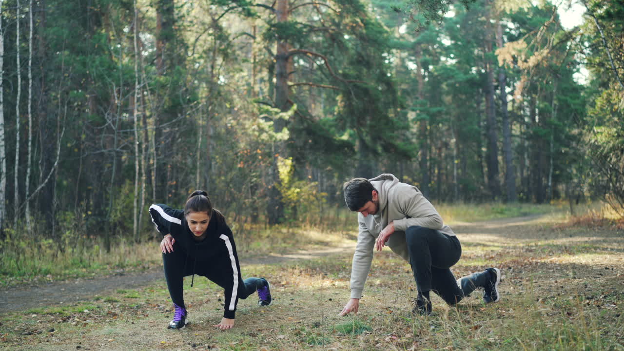 Couple Stretching Outdoors in the Forest