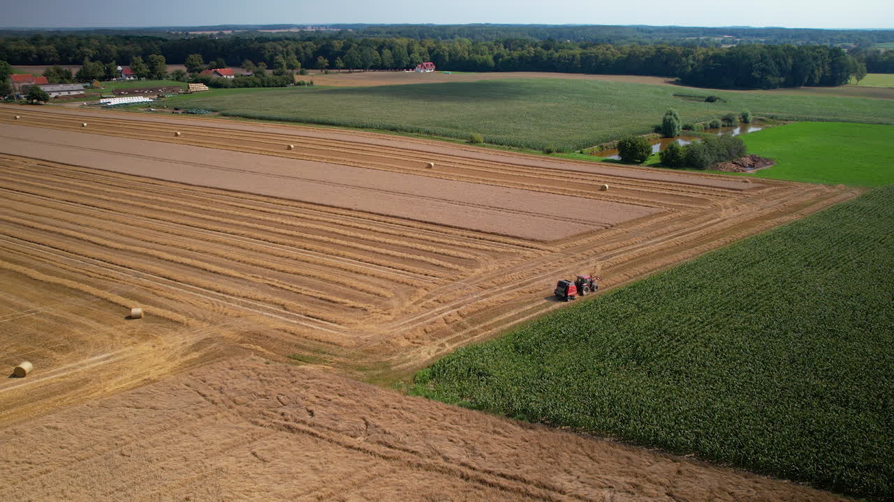 Aerial: harvester machine harvesting grains at farmland in Poland