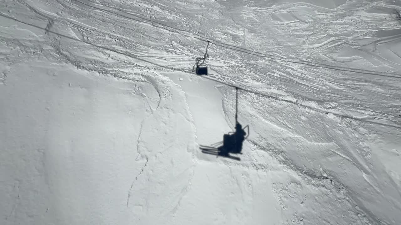Shadows of a chairlift in a ski resortMedium shot
