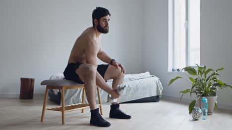 man doing dumbbell exercises at home