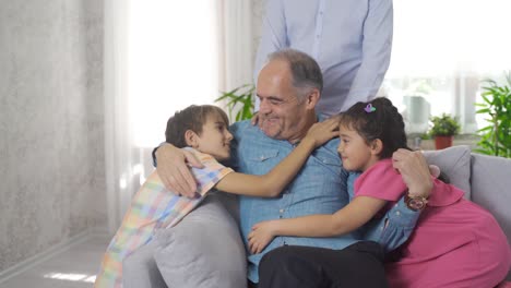 Happy-family-picture.-Grandchildren-hug-their-sad-grandfather.