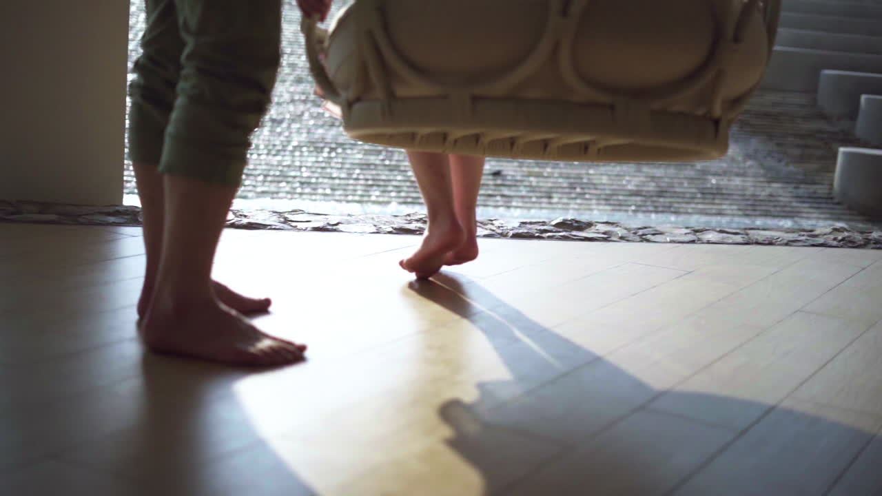 Legs video of young couples playing swings at sunset