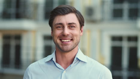 Portrait-of-man-smiling-on-camera-on-the-street