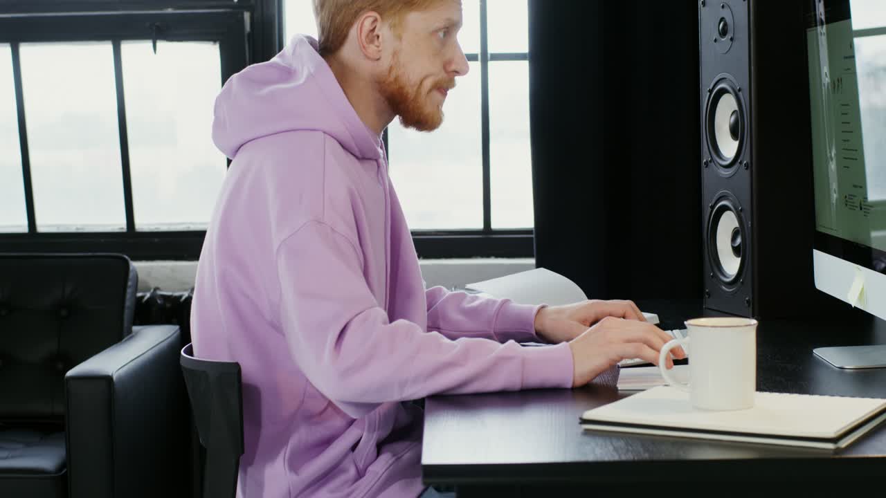 Man working on a computer in a home office.
