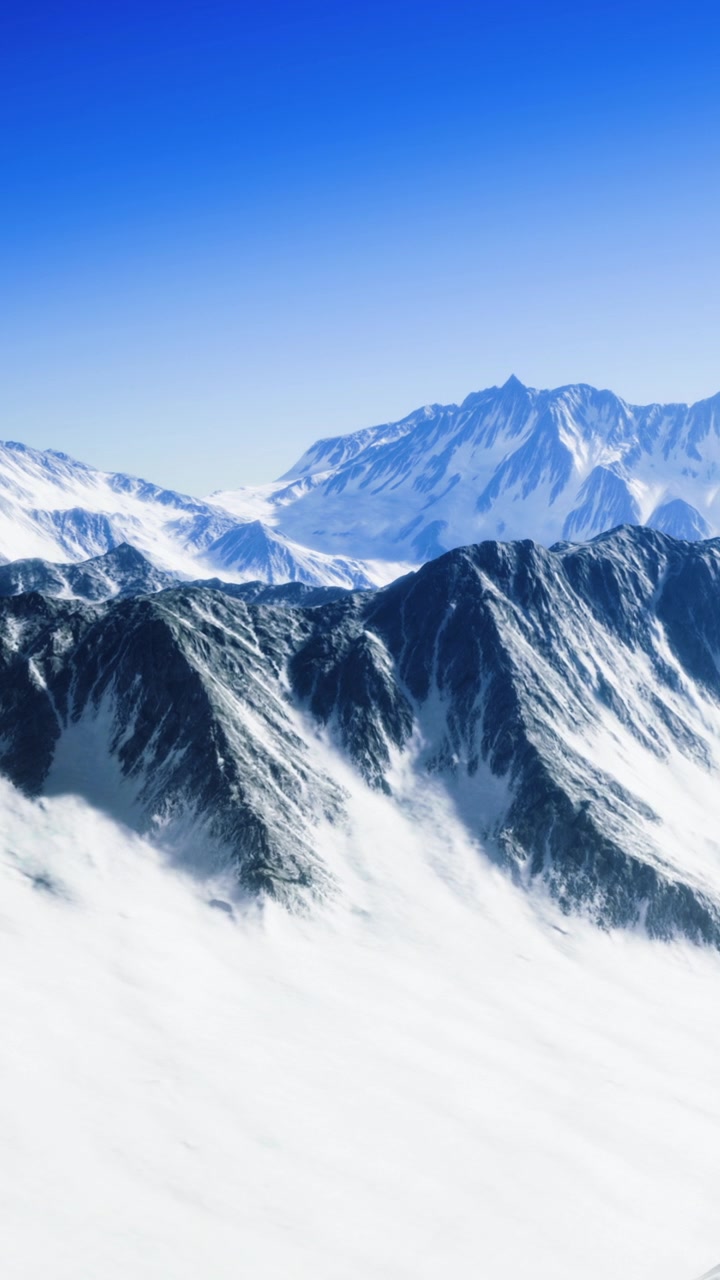 Snowy mountains rise under blue sky in a clear winter day