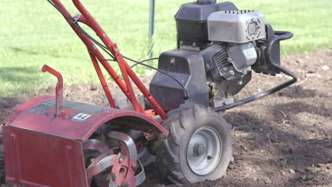 man tilling the garden in slomo